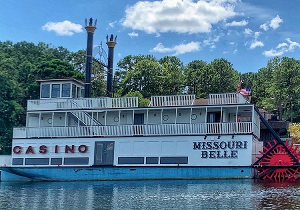 old boat is tied up to the REI Boathous